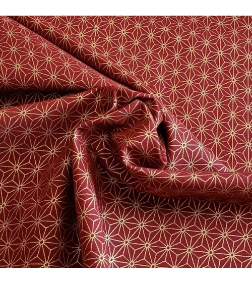 Japanese cotton fabric with golden asanohas over maroon