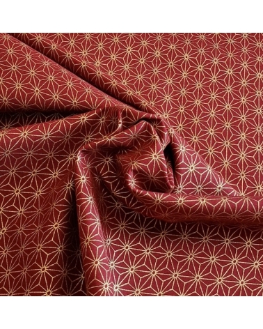 Japanese cotton fabric with golden asanohas over maroon