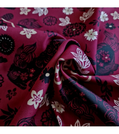 Japanese fabric. Okinawa Shisa katagami bourdeaux background.