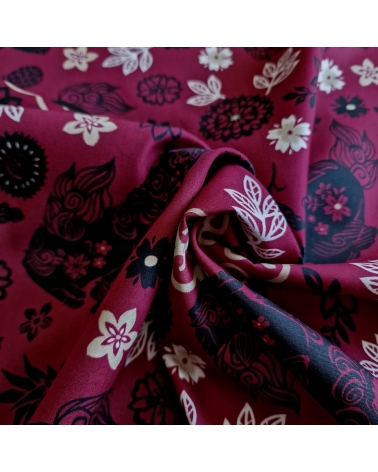 Japanese fabric. Okinawa Shisa katagami bourdeaux background.
