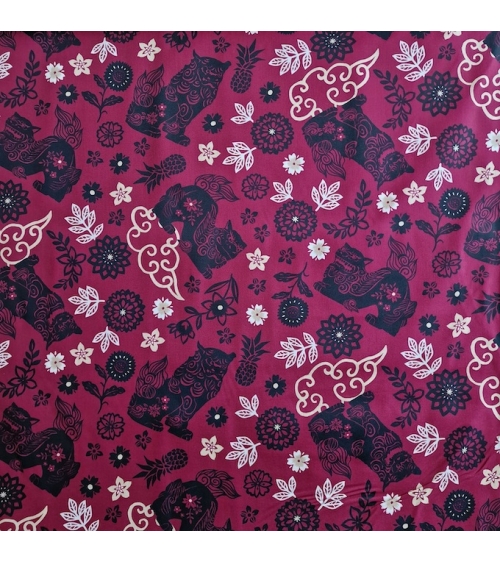 Japanese fabric. Okinawa Shisa katagami bourdeaux background.