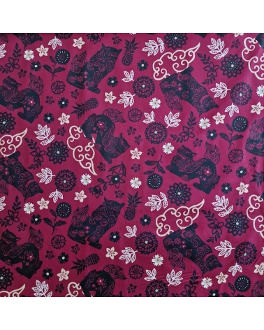 Japanese fabric. Okinawa Shisa katagami bourdeaux background.