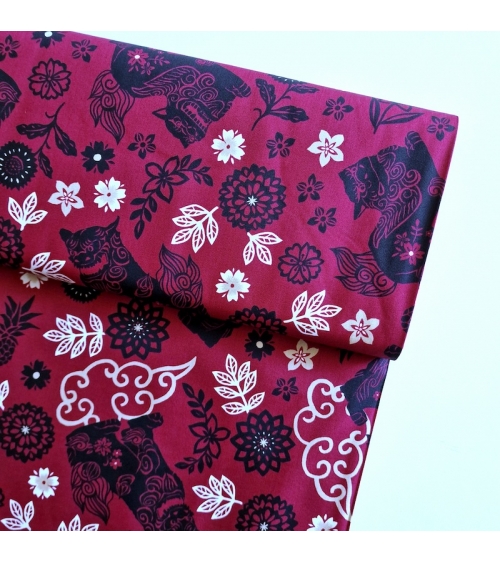 Japanese fabric. Okinawa Shisa katagami bourdeaux background.