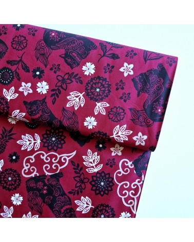 Japanese fabric. Okinawa Shisa katagami bourdeaux background.